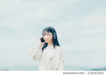 Lifestyle of a woman in her 20s making a phone call with a calm expression 126383263