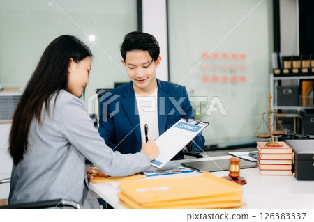 Woman lawyer hand and women client shaking hand collaborate on working agreements Woman lawyer hand and women client shaking hand collaborate on working agreements 126383337