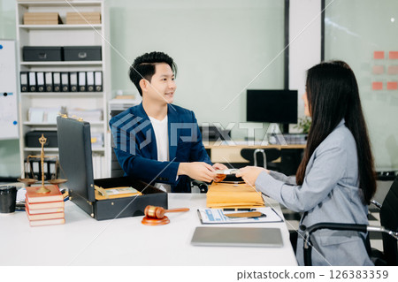 justice and law concept.passing bribe money in the envelop at lawyer office. 126383359