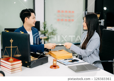 justice and law concept.passing bribe money in the envelop at lawyer office. 126383361
