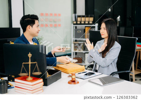 justice and law concept.passing bribe money in the envelop at lawyer office. 126383362