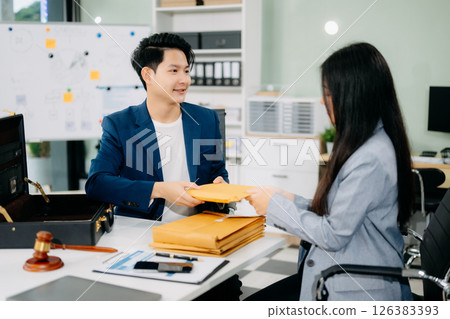 justice and law concept.passing bribe money in the envelop at lawyer office. justice and law concept.passing bribe money in the envelop at lawyer office. 126383393