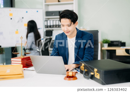 Attractive young lawyer in office Business man and lawyers discussing contract papers laptop 126383402