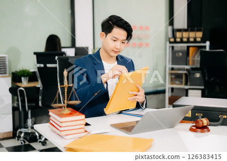 Attractive young lawyer in office Business man and lawyers discussing contract papers laptop 126383415
