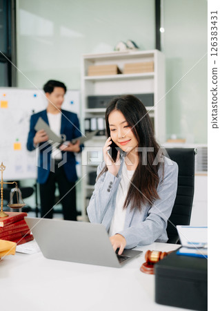 female lawyer celebrating success with documents at a desk, featuring a gavel, scales of justice, female lawyer celebrating success with documents at a desk, featuring a gavel, scales of justice, 126383431
