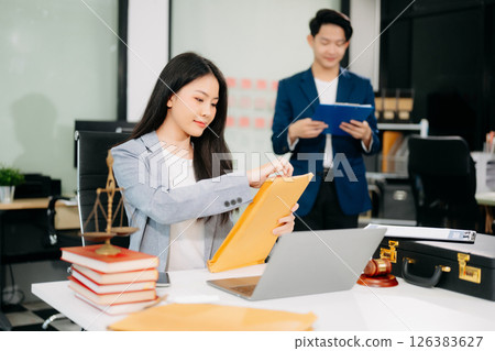 female lawyer celebrating success with documents at a desk, featuring a gavel, scales of justice, female lawyer celebrating success with documents at a desk, featuring a gavel, scales of justice, 126383627