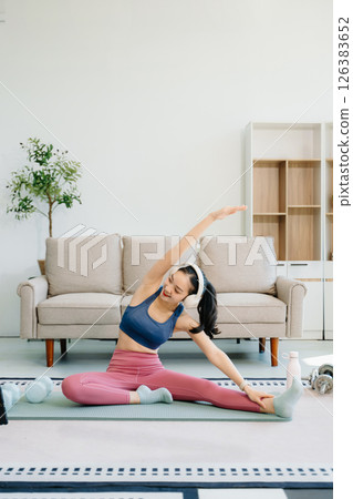 Asian Woman Doing Yoga and Watching Online Tutorials on tablet, Training 126383652