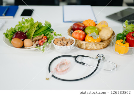Fresh vegetables, fruits, and healthy food concepts combined with medical nutrition care, wellness, and diet planning Fresh vegetables, fruits, and healthy food concepts combined with medical nutrition care, wellness, and diet planning 126383862