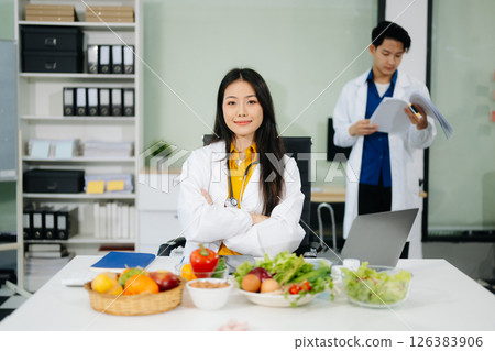 Nutritionists consulting on healthy food choices, meal planning, and wellness concepts Nutritionists consulting on healthy food choices, meal planning, and wellness concepts 126383906