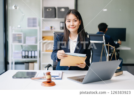 Asian woman lawyer working and gavel, tablet, laptop in front, Advice justice and law concept. 126383923