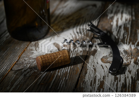 Uncorking memories over a rustic wooden table in warm evening light 126384389
