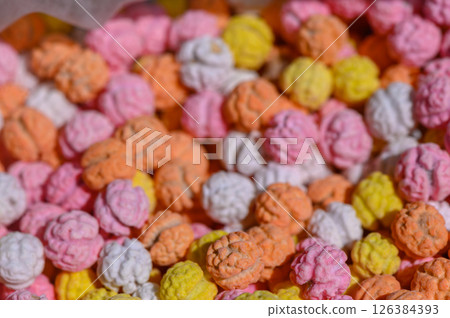 Colorful candy popcorn fills a festive container at a vibrant outdoor market during a sunny afternoon gathering in the city Colorful candy popcorn fills a festive container at a vibrant outdoor market during a sunny afternoon gathering in the city 126384393