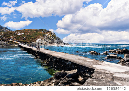 Group of tourists on the path that separates part of the beach from Illas Cies in Vigo, Pontevedra, Rias Baixas, Galicia Group of tourists on the path that separates part of the beach from Illas Cies in Vigo, Pontevedra, Rias Baixas, Galicia 126384442