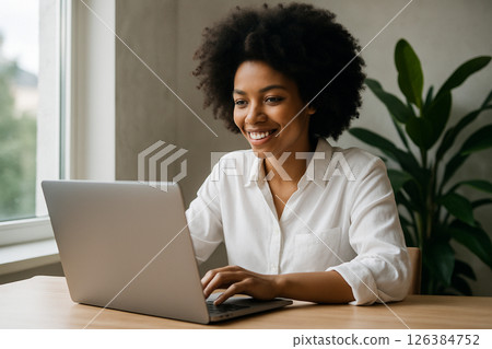 Smiling Woman Working Remotely at Home Smiling Woman Working Remotely at Home 126384752