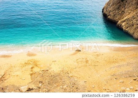 Top view of beautiful blue sea water with sand beach among mount Top view of beautiful blue sea water with sand beach among mount 126386259