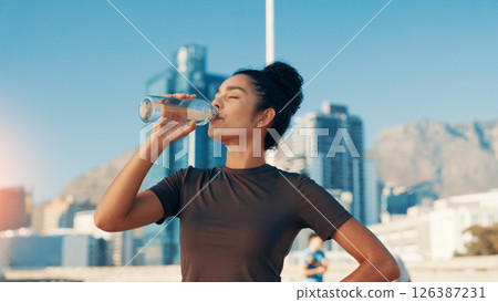Woman, fitness or drinking water in city for break, natural sustainability or refreshment. Active, female person or thirsty runner with mineral liquid or aqua beverage for hydration, recovery or rest Woman, fitness or drinking water in city for break, natural sustainability or refreshment. Active, female person or thirsty runner with mineral liquid or aqua beverage for hydration, recovery or rest 126387231