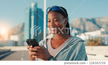 Happy, black woman and fitness with phone in city for workout app, communication or performance. Active, female person or user with smile on mobile smartphone for exercise routine or schedule in town Happy, black woman and fitness with phone in city for workout app, communication or performance. Active, female person or user with smile on mobile smartphone for exercise routine or schedule in town 126387239