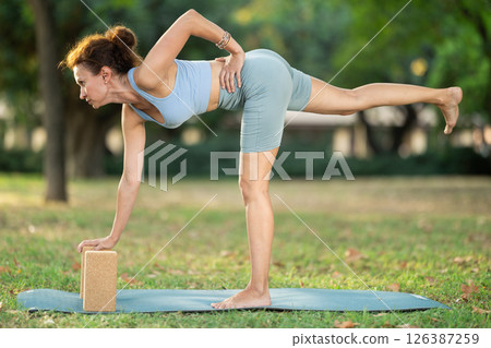 Adult woman doing yoga with blocks 126387259