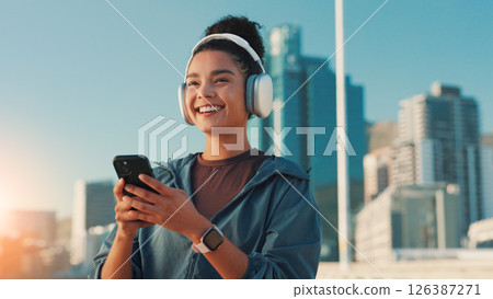 Fitness, music and phone with woman in city for break from cardio training or running. Exercise, headphones and smile with athlete or runner outdoor in urban town for sports, vision or workout Fitness, music and phone with woman in city for break from cardio training or running. Exercise, headphones and smile with athlete or runner outdoor in urban town for sports, vision or workout 126387271