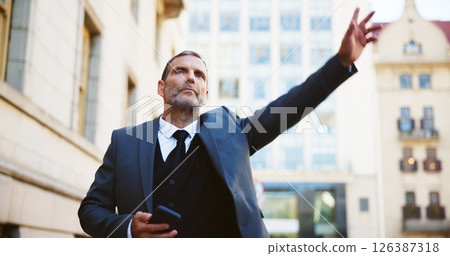 Businessman, phone and calling taxi in city for cab ride, transportation service or travel. Man, employee or traveler hailing with mobile smartphone or app for lift or local commute in an urban town 126387318