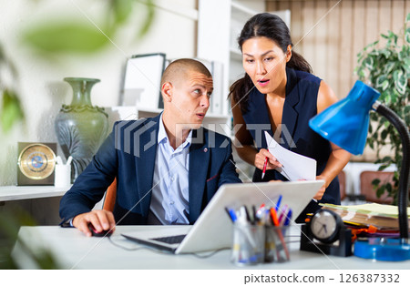 Business people working with papers together Business people working with papers together 126387332