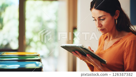 Home, serious and woman with tablet, recycle bin and online reading for email, news report and app. Mature person, apartment and lady with tech, ecology or internet with sustainability or connection 126387382