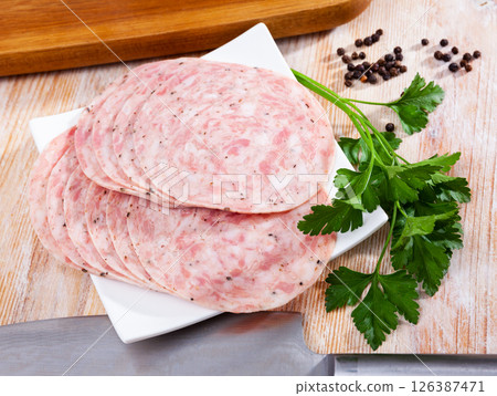 Traditional spanish sausage slices on wooden background closeup 126387471