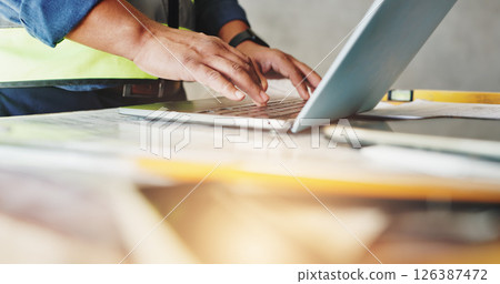 Man, laptop and hands with typing for construction, floor plan inspection and building renovation of development. Engineer, technology and project management with maintenance for infrastructure 126387472
