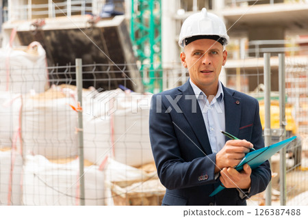 Male engineer checking work process in construction site 126387488