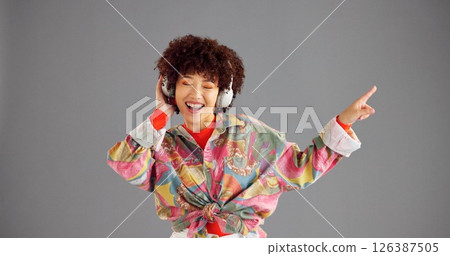 Headphones, smile and woman in studio, listening to music and singing on grey background. Person, space or happy model with confidence, fashion and energy with audio, streaming radio and sound Headphones, smile and woman in studio, listening to music and singing on grey background. Person, space or happy model with confidence, fashion and energy with audio, streaming radio and sound 126387505