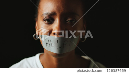 Woman, tape and mouth for help in studio for silence, voice and censorship by black background. African person, portrait and text on lips with depression, sad and mental health with space in Nigeria Woman, tape and mouth for help in studio for silence, voice and censorship by black background. African person, portrait and text on lips with depression, sad and mental health with space in Nigeria 126387669