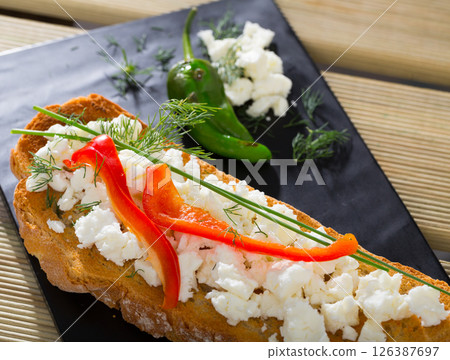 Canape with young cheese and pepper 126387697