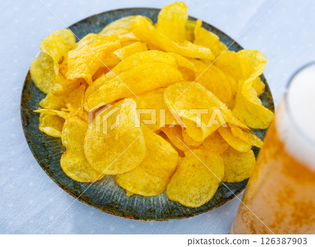 Appetizing chips with a glass of beer Appetizing chips with a glass of beer 126387903