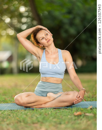 Various yoga poses performed by slender woman in fresh air in summer garden Various yoga poses performed by slender woman in fresh air in summer garden 126387943