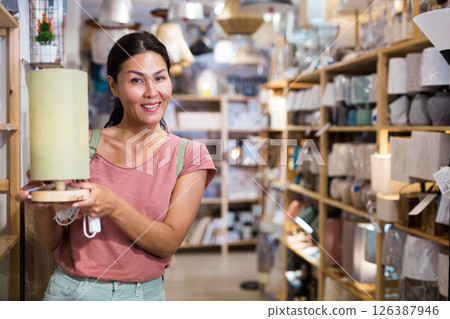 Woman with table lamp in store 126387946