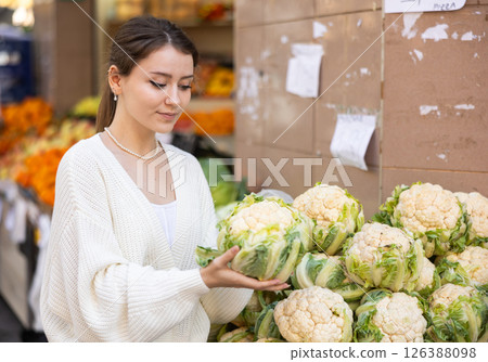 Woman choosing cabbage at the market Woman choosing cabbage at the market 126388098