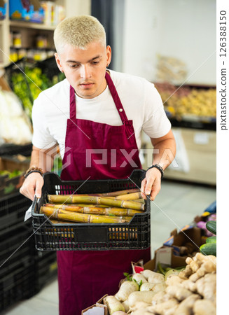 Young guy seller with box of bamboo 126388150