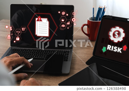 Risk managemen insuranc control Business person analyzing digital risk and security threats laptop and tablet, emphasizing cybersecurity and data 126388498