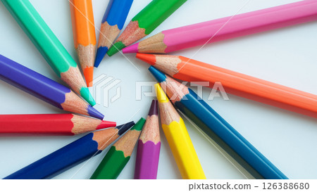 Colorful pencils arranged in a radial pattern on a white background. Perfect for themes like creativity, education, art, or back-to-school concepts. 126388680