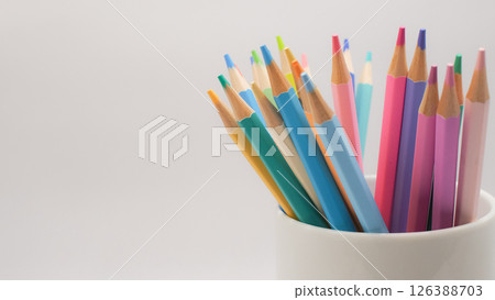 The colored pencils arranged in a white cup evoke a sense of potential with negative space emphasize motion and openness 126388703