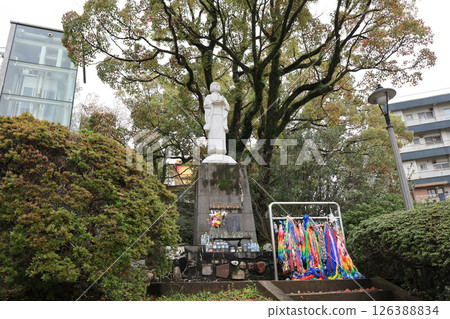March 28 2025 Statue in Park Surrounded by Trees and Visitors 126388834