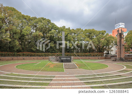March 28 2025 March 28 2025 Memorial Site Surrounded by Green Trees Under a Cloudy Sky 126388841