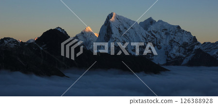 Sun lit mountains Ama Dablam and Cholatse at sunset, view from the Gokyo Valley, Nepal. 126388928