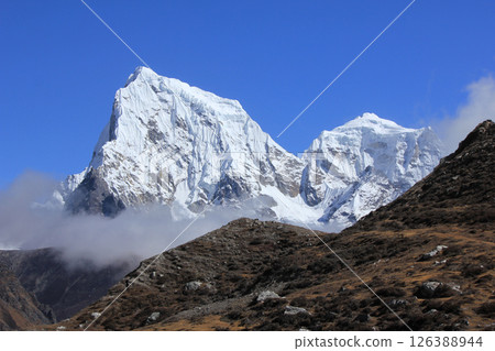 Snow covered mountains Cholatse and Tobuche seen from the Gokyo Valley, Nepal. 126388944