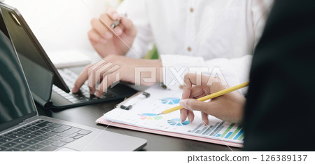 Business people meeting to analyze and discuss the situation on the financial report in meeting room. 126389137