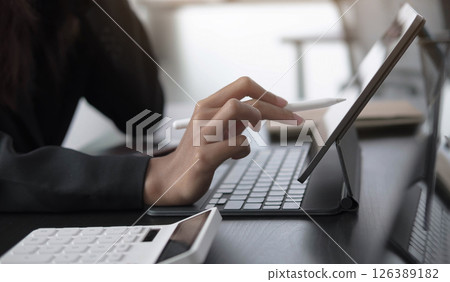 businesswoman use a digital tablet to check financial data. businesswoman use a digital tablet to check financial data. 126389182