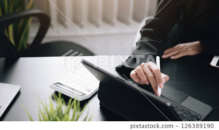 businesswoman use a digital tablet to check financial data. businesswoman use a digital tablet to check financial data. 126389190