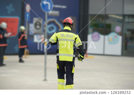 Fire and Rescue Worker Wearing High Visibility Jacket Walking Away 126389252