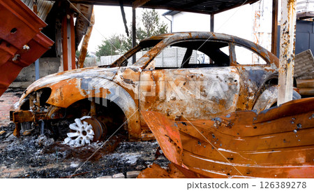 Real video of a bombed-out village during the Russian-Ukrainian war. Destroyed house and burned car Real video of a bombed-out village during the Russian-Ukrainian war. Destroyed house and burned car 126389278