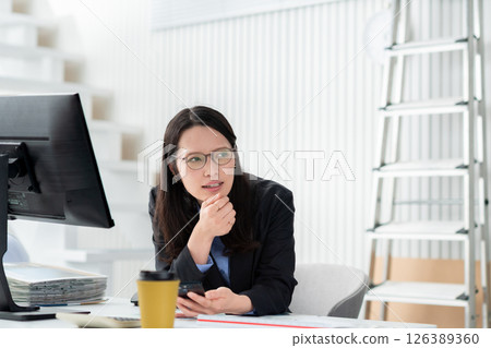 A construction company employee with a smartphone looking troubled 126389360